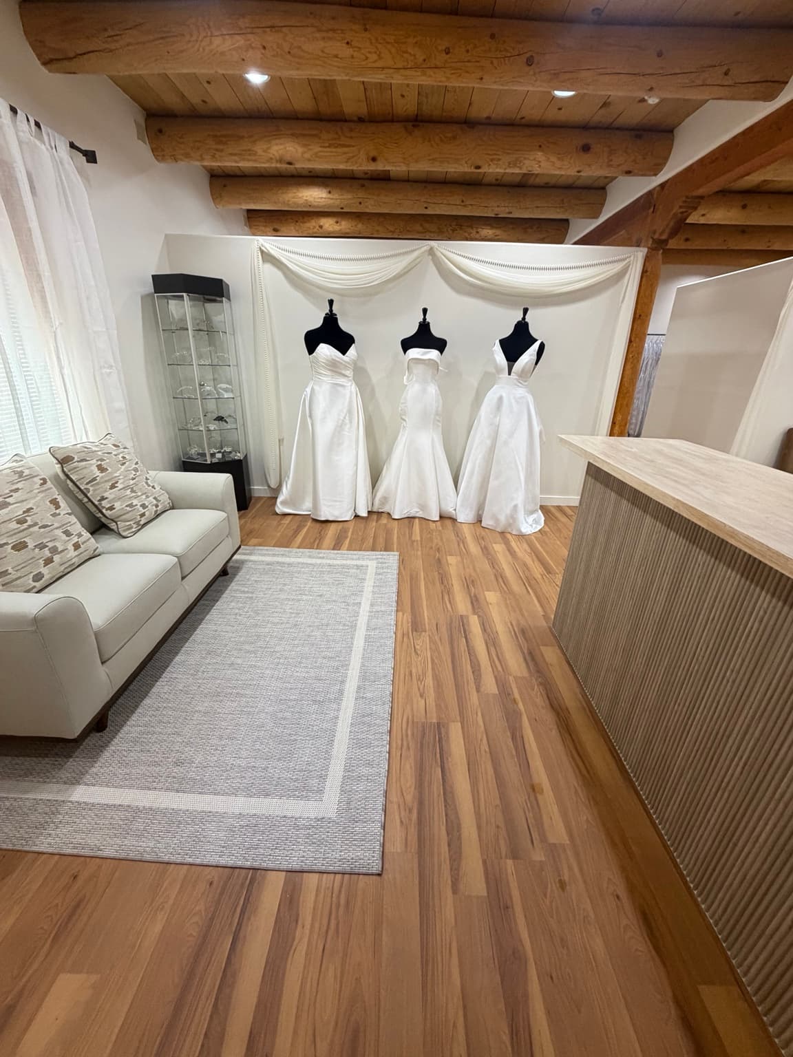 Bridal showroom entrance with featured gowns and lounge seating